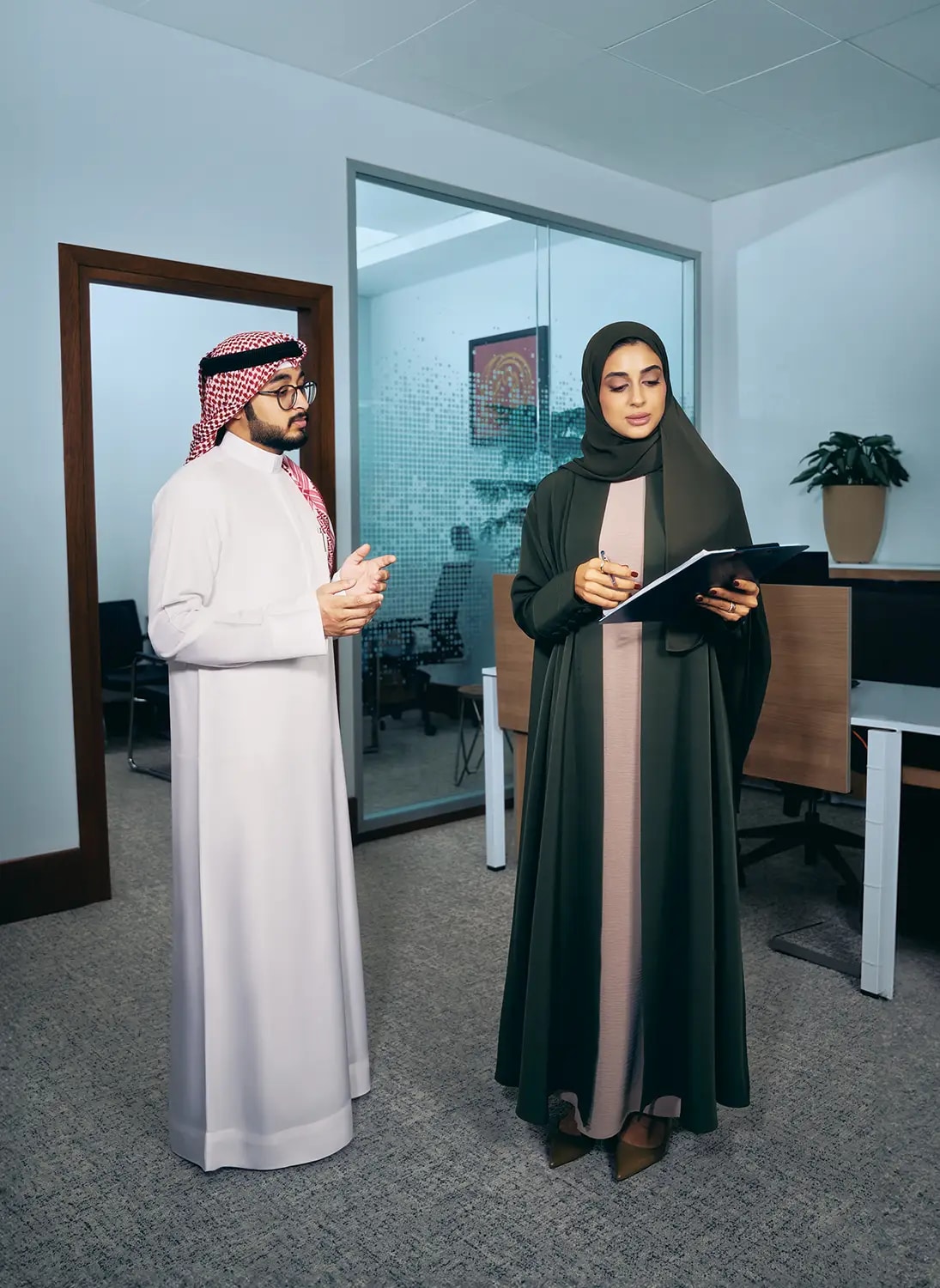 Arab man and women talking in the office